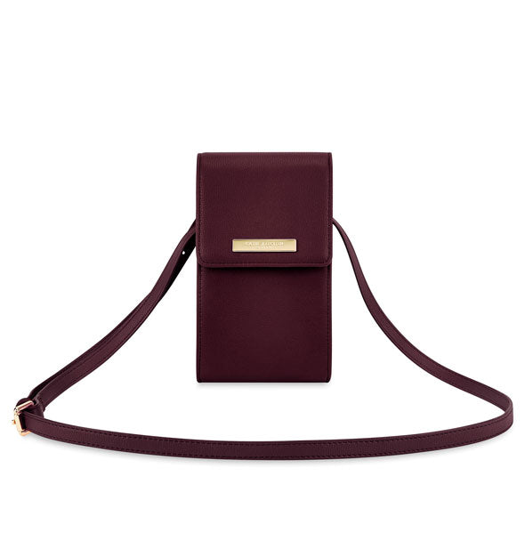 Dark plum crossbody purse with gold label and gold strap buckle