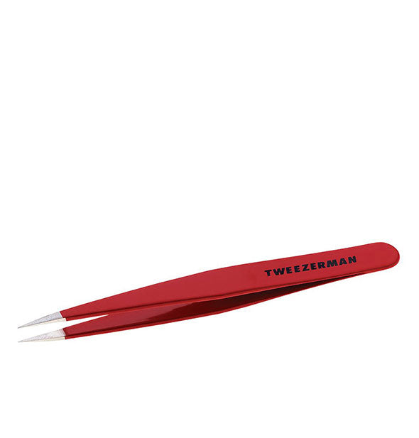 Red tweezer with pointed stainless steel tips and black "Tweezerman" logo printed on the handle