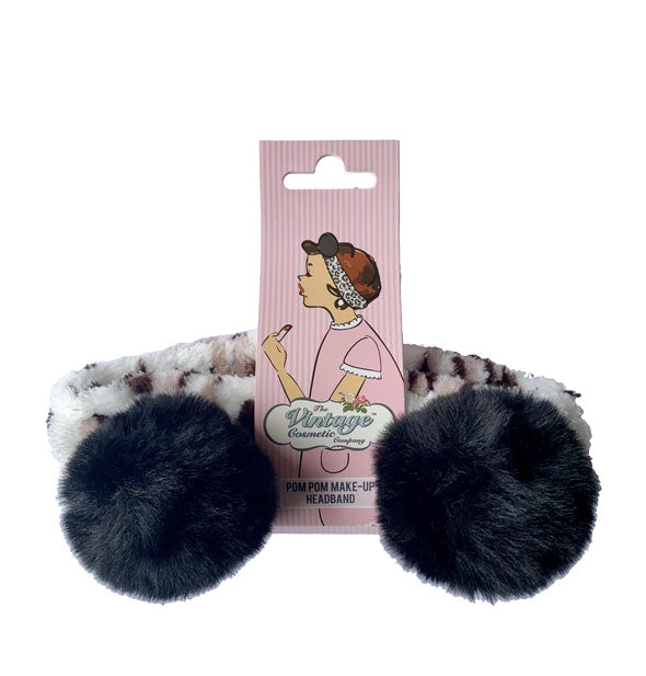Leopard print and black pom pom headband attached to The Vintage Cosmetic Company blister card