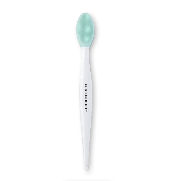 Cricket brush for lip exfoliation features a teal brush head with fine bristle pattern