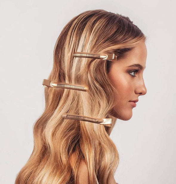 Model wears extra-large rose gold styling clips in hair