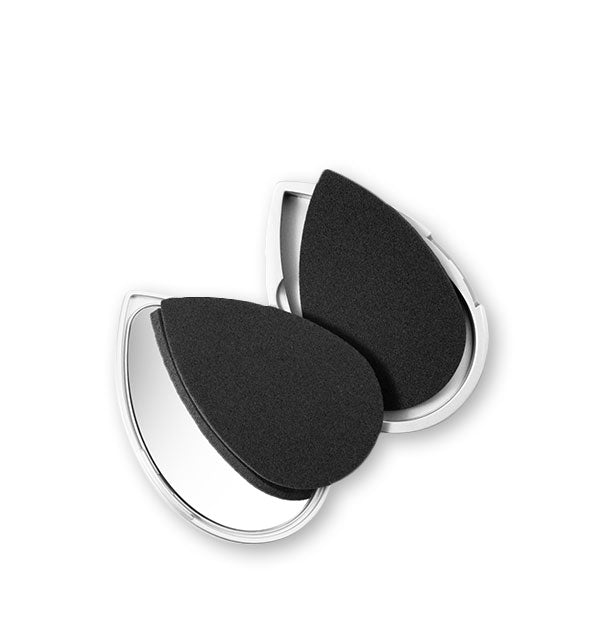 Two black facial sponges in a compact