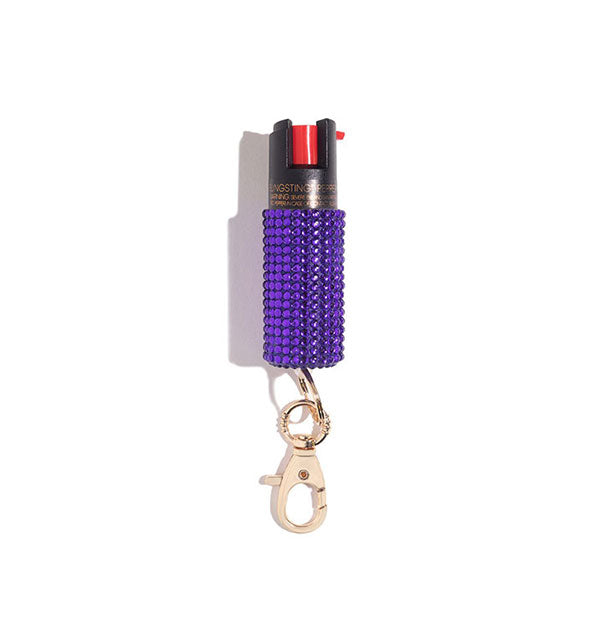 Purple rhinestone-encrusted pepper spray canister with rose gold lobster clasp attached