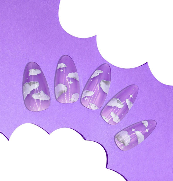 Five press-on nails featuring white clouds on a purple background