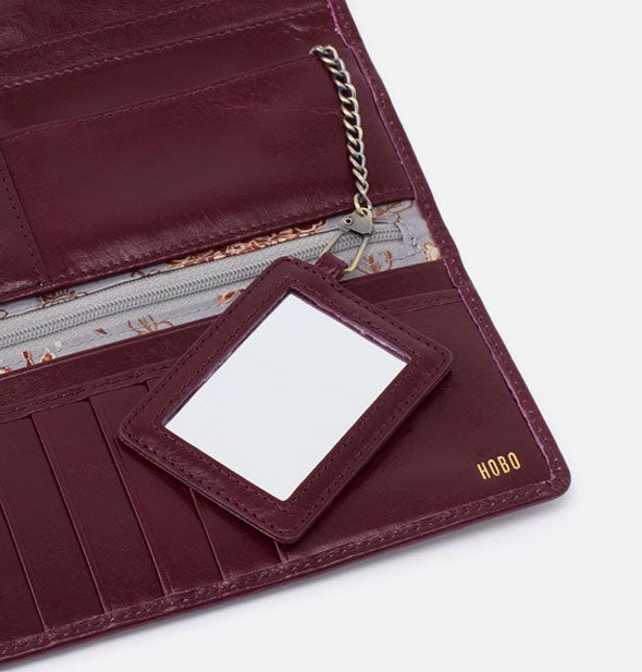Maroon leather wallet interior includes a mirror with chain attached