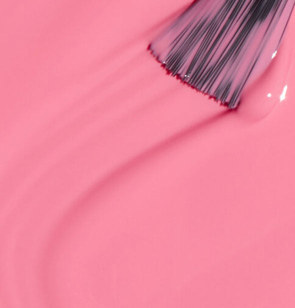 Pink nail polish with a brush tip swiped through it
