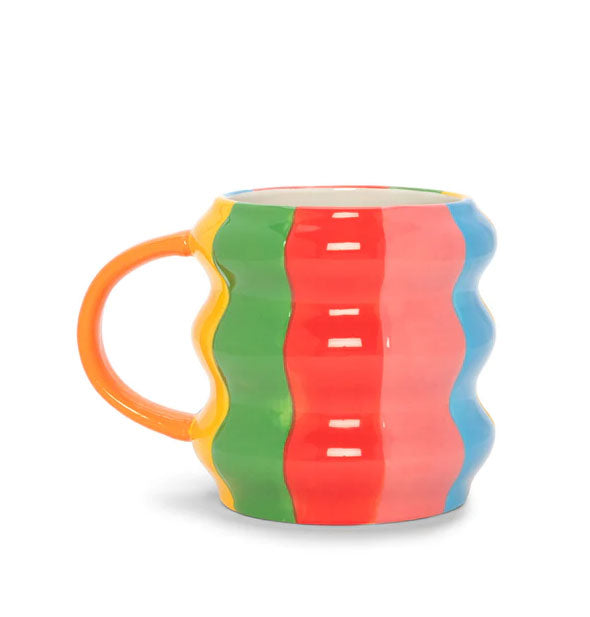 Ceramic coffee mug with wavy shape is hand-painted in colorful stripes of yellow, green, red, pink, and blue