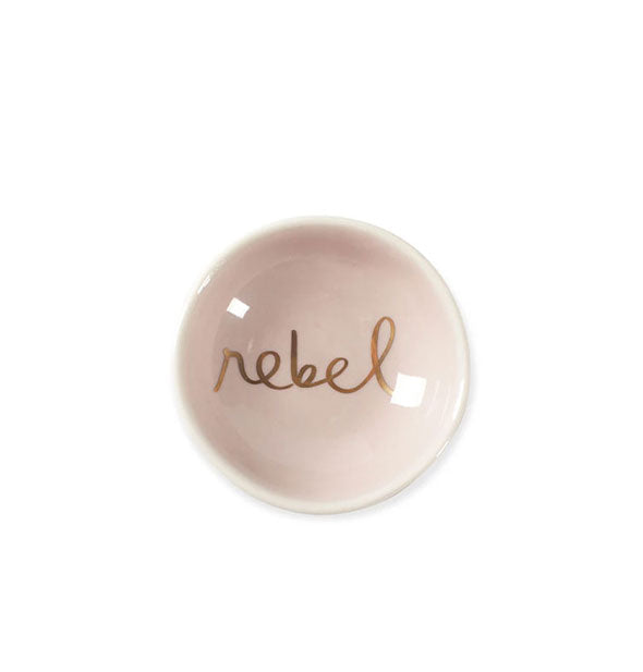 Round pale pink dish says, "Rebel" in the bottom in metallic gold script