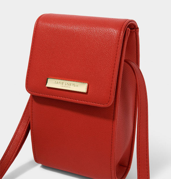 Closeup of red Katie Loxton purse with metallic gold label