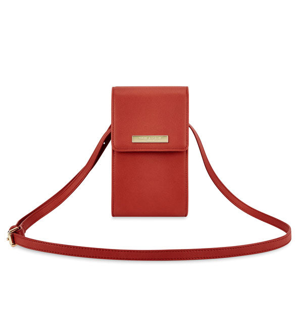 Red purse with gold label and strap buckle