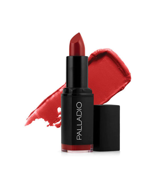 Black tube of Palladio lipstick with cap removed and color swatch behind in a bright scarlet shade called Red Carpet