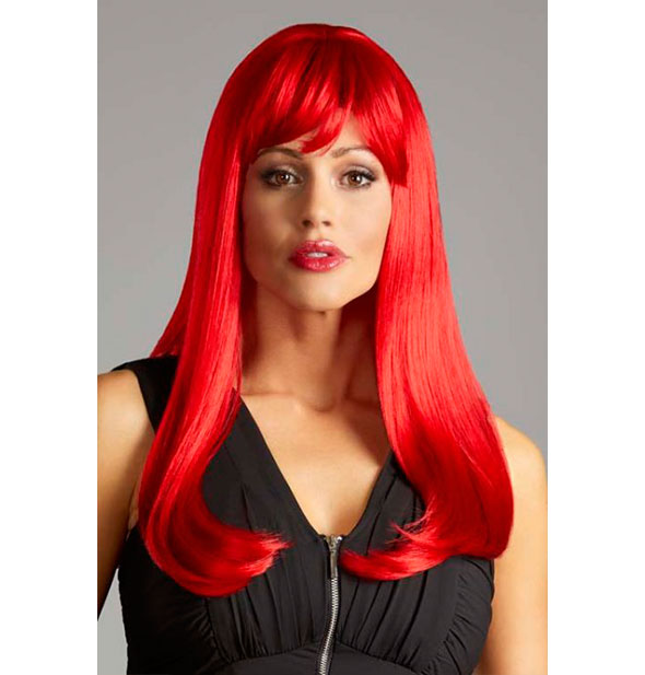 Model wearing a long, bright red wig with bangs.
