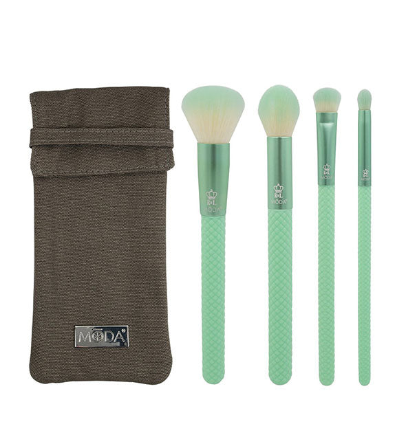 Four green makeup brushes with ombré bristles and faceted handles next to olive drab Moda carrying case