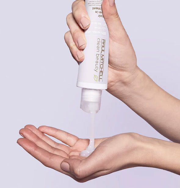 Model dispenses Paul Mitchell Clean Beauty Repair Leave-In Treatment from bottle into hand