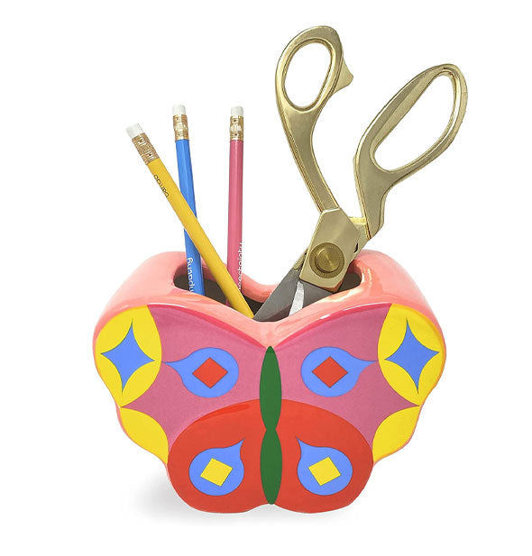 Butterfly vase holds pencils and scissors for size reference and as a storage suggestion
