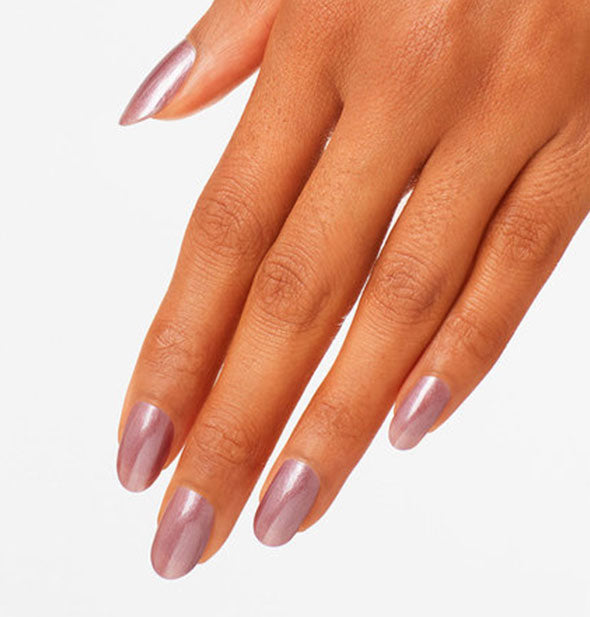 Model's hand wears a shimmering shade of mauve nail polish