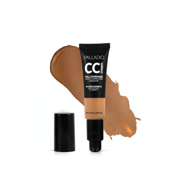 Tube of Palladio CC Cream Full-Coverage Color Correcting +Skincare in a dark shade with cap removed sample swatch behind