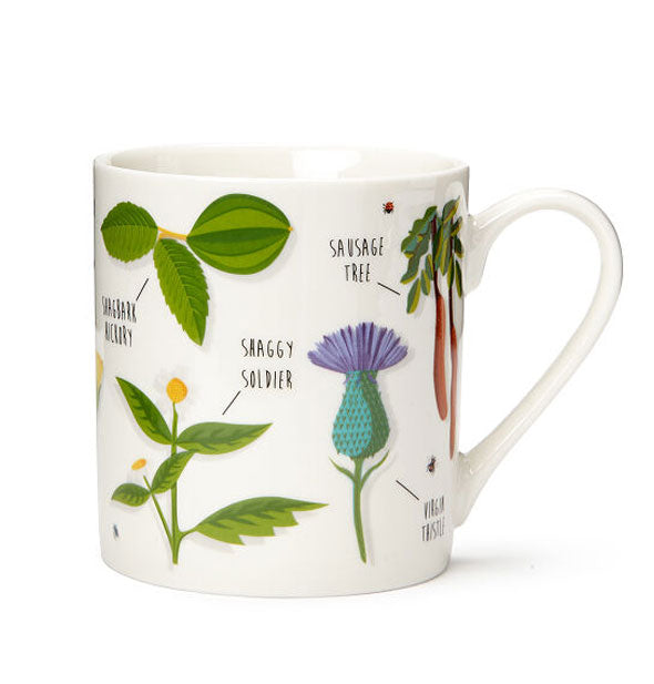 White mug with labeled plant illustrations, like "Shaggy Soldier" and "Sausage Tree"