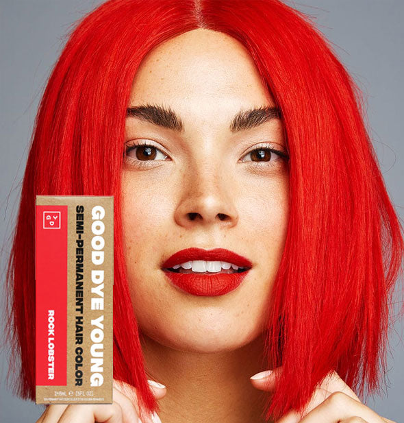 Model with bright red-orange hair color by Good Dye Young in the shade Rock Lobster