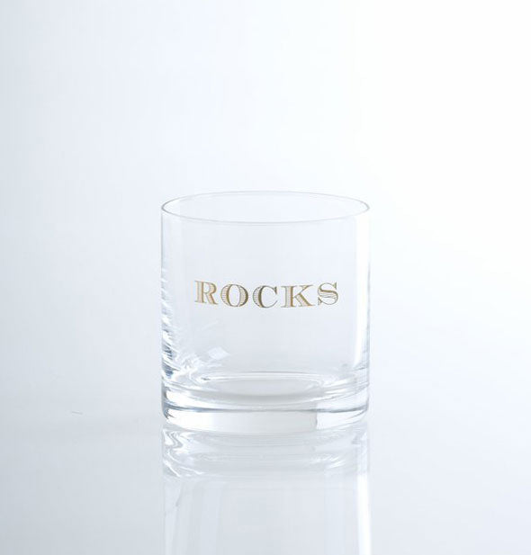 Clear bar glass says, "Rocks" in gold lettering