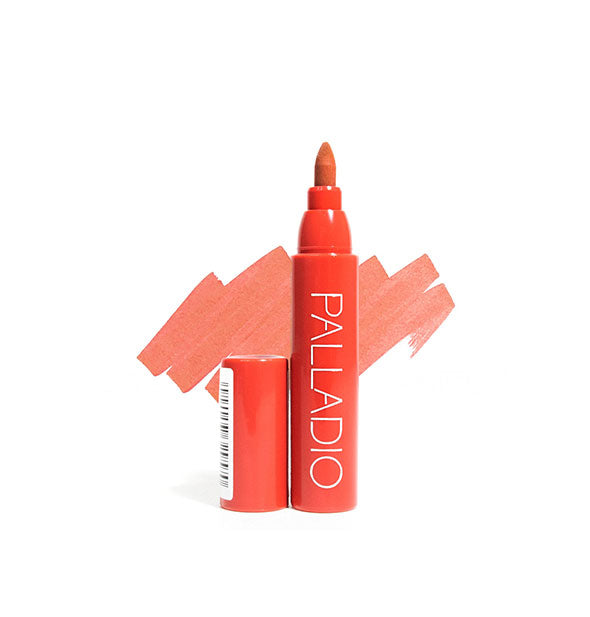 Coral Palladio lip stain pen with cap removed and sample color swatch drawn behind