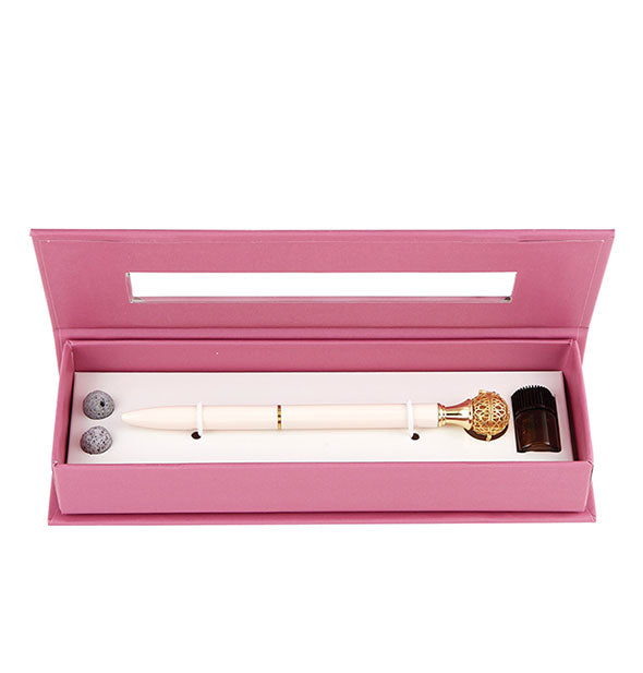 Rose essential oil diffuser pen in pink box with lava balls and amber glass jar