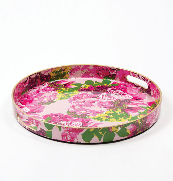 Round pink and green serving tray with handles cut into a shallow edge