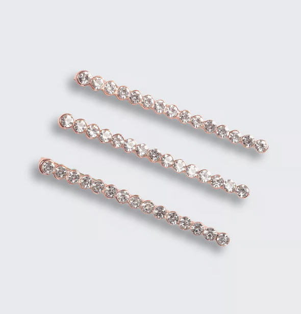 Three rhinestone-covered hair pins with a rose gold tone