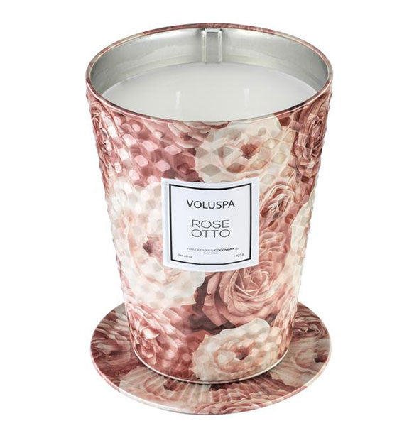 Large pink rose print faceted metallic Rose Otto Voluspa candle tin with lid removed to show double wicks and placed underneath as a coaster