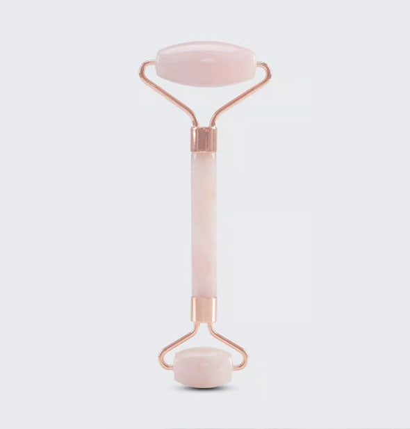 Double-ended rose quartz facial roller with gold hardware