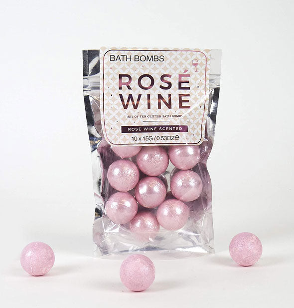 Bag of pearlescent pink Rosé Wine bath bombs with three bombs removed and placed in the foreground