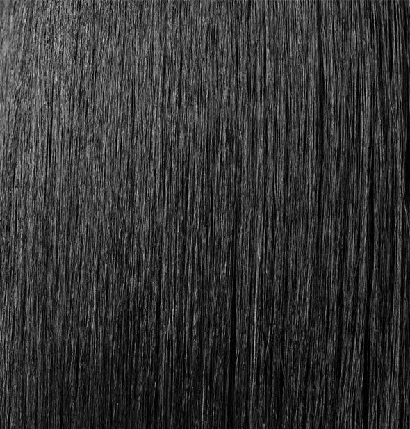 Closeup of straight, shiny hair that is styled with Oribe Royal Blowout Heat Styling Spray