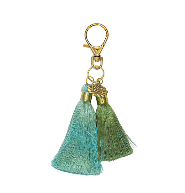 Seafoam and forest green tassels hang from a gold keyring with lotus charm