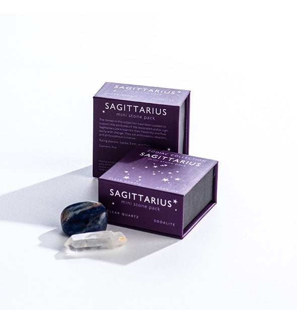 Two dark purple Sagittarius Mini Stone Packs with crystals displayed in front.