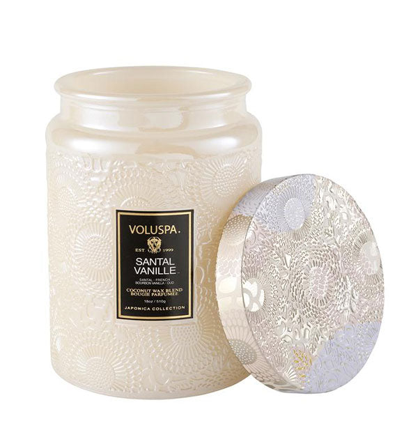 A Large Embossed Glass Jar Candle in Santal Vanille fragrance.