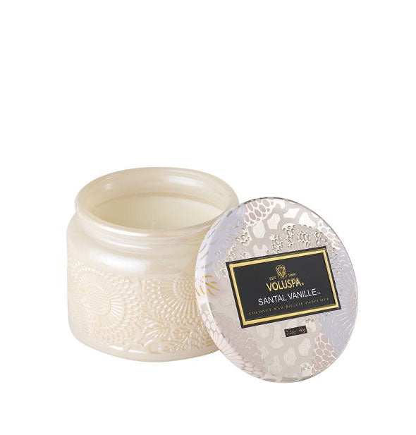 A Petite Embossed Glass Jar Candle in Santal Vanille fragrance.