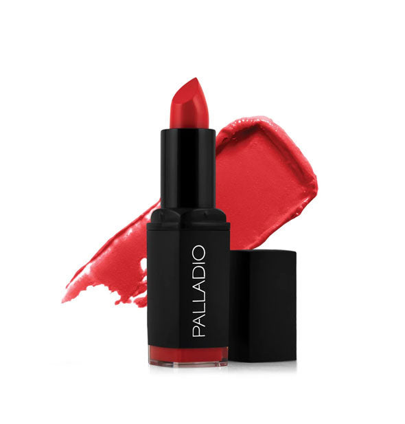 Black tube of Palladio lipstick with cap removed and color swatch behind in a bright pinkish-red shade called Scarlet