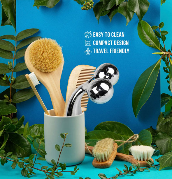 Sculpting Massager is shown with wooden toothbrush, bath brush, comb, and other wooden bath brushes among green foliage on a blue background; caption says, "Easy to clean; Compact design; Travel-friendly"