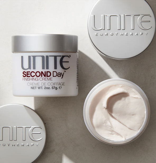 Pots of Unite SECOND Day Finishing Crème, one of which is opened to show creamy white product inside from the top