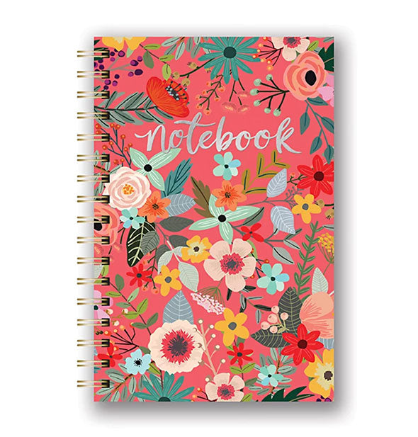 Notebok with all-over flower design on coral background accented with silver foil lettering and gold wire binding