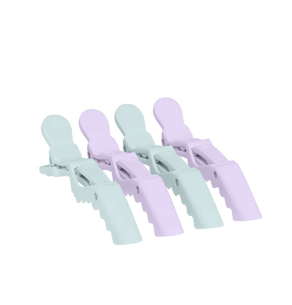 Four crocodile-style clips for hair, two each pastel purple and teal