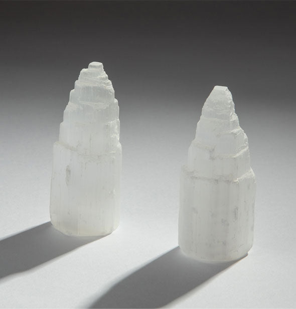 Two selenite crystal towers with tiered tops