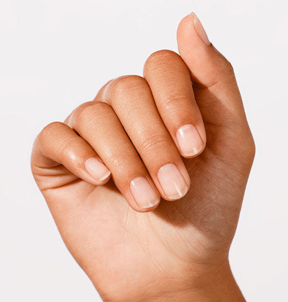 Model's hand wears a natural-look nail treatment