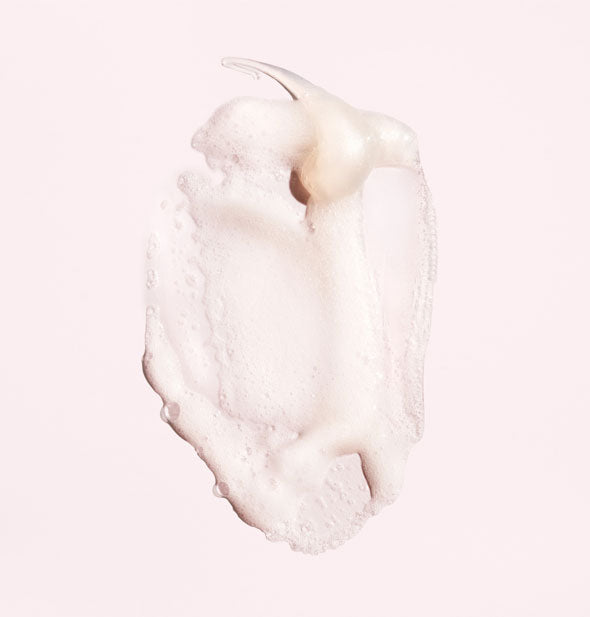 Sample of Oribe Serene Scalp Anti-Dandruff Shampoo shows product's consistency