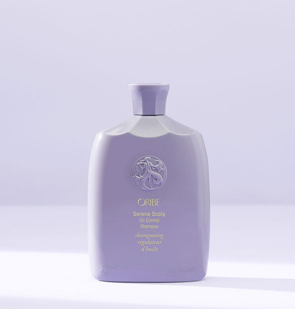 Faceted purple bottle of Oribe Serene Scalp Oil Control Shampoo on a purple background