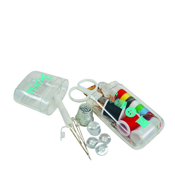 Sewing Kit case open with contents—including pins, thimble, buttons, thread, and scissors—partially shown