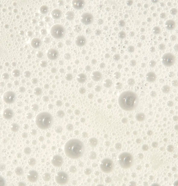 Closeup of foamy Paul Mitchell Tea Tree Scalp Care Anti-Thinning Shampoo