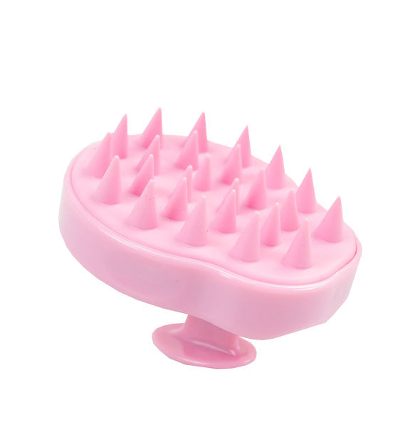 Pink brush with spiny bristles and handle