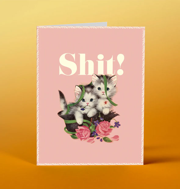 Greeting card with illustration of two kittens sitting in a torn-apart hat with pink flowers says, "Shit!"