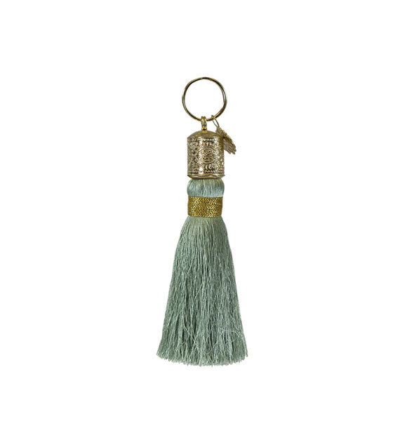 Gray-green tassel keychain with decorative gold hardware